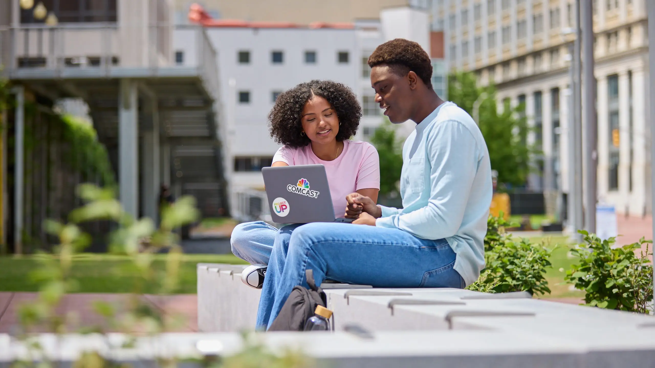 Two people sharing laptop