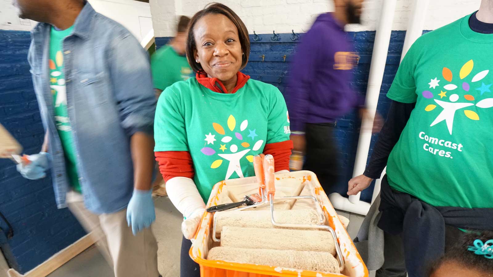 Comcast Cares Day volunteer with paint rollers