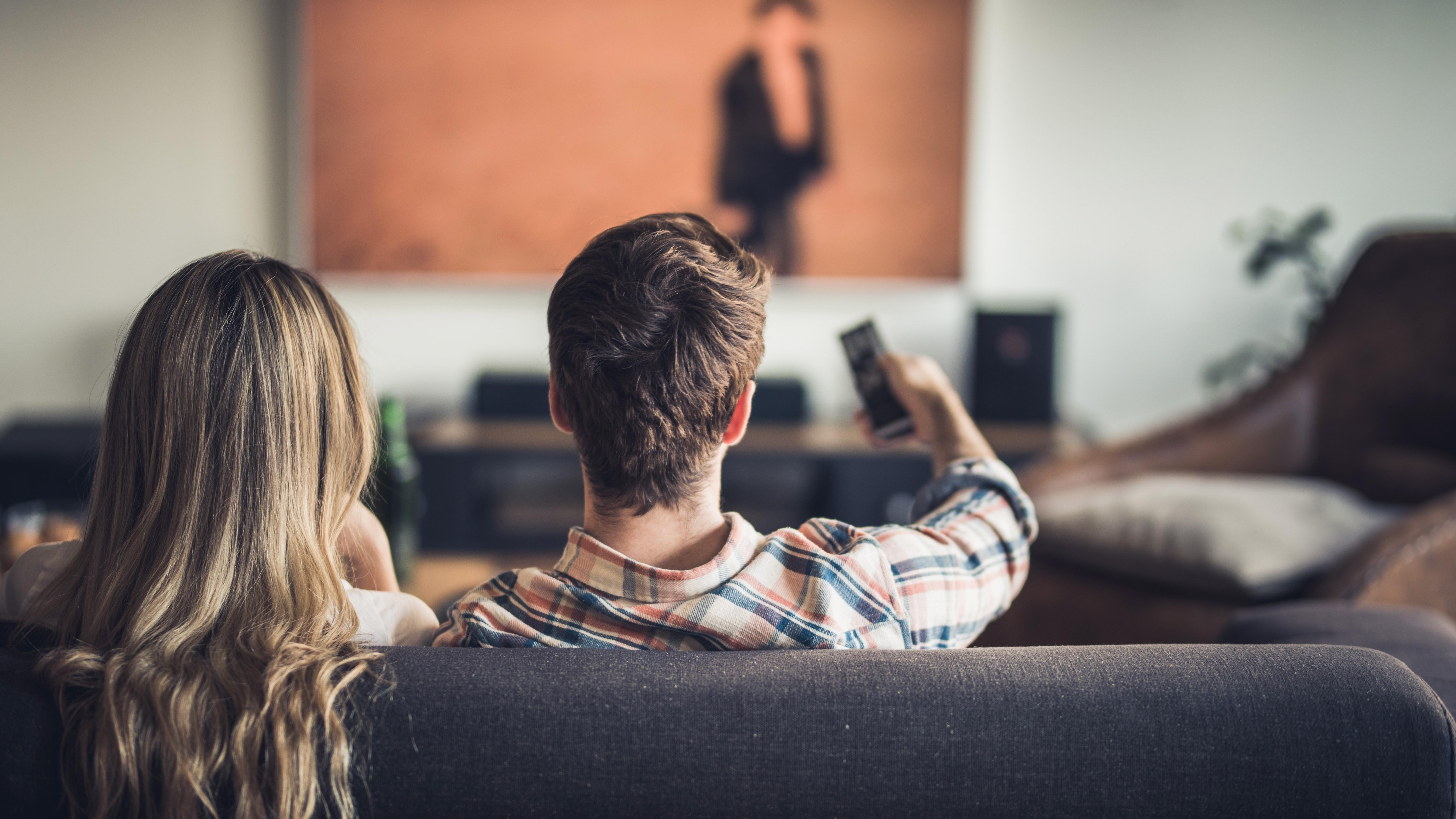 two people sitting on a couch together