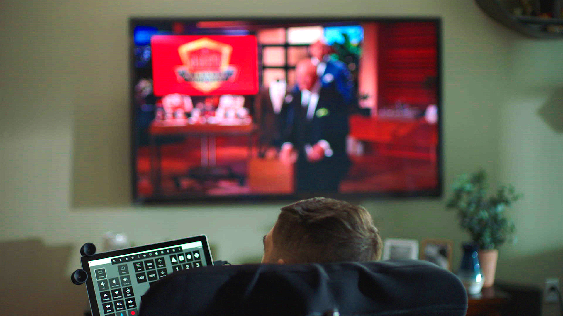 A disabled man watching eye control TV