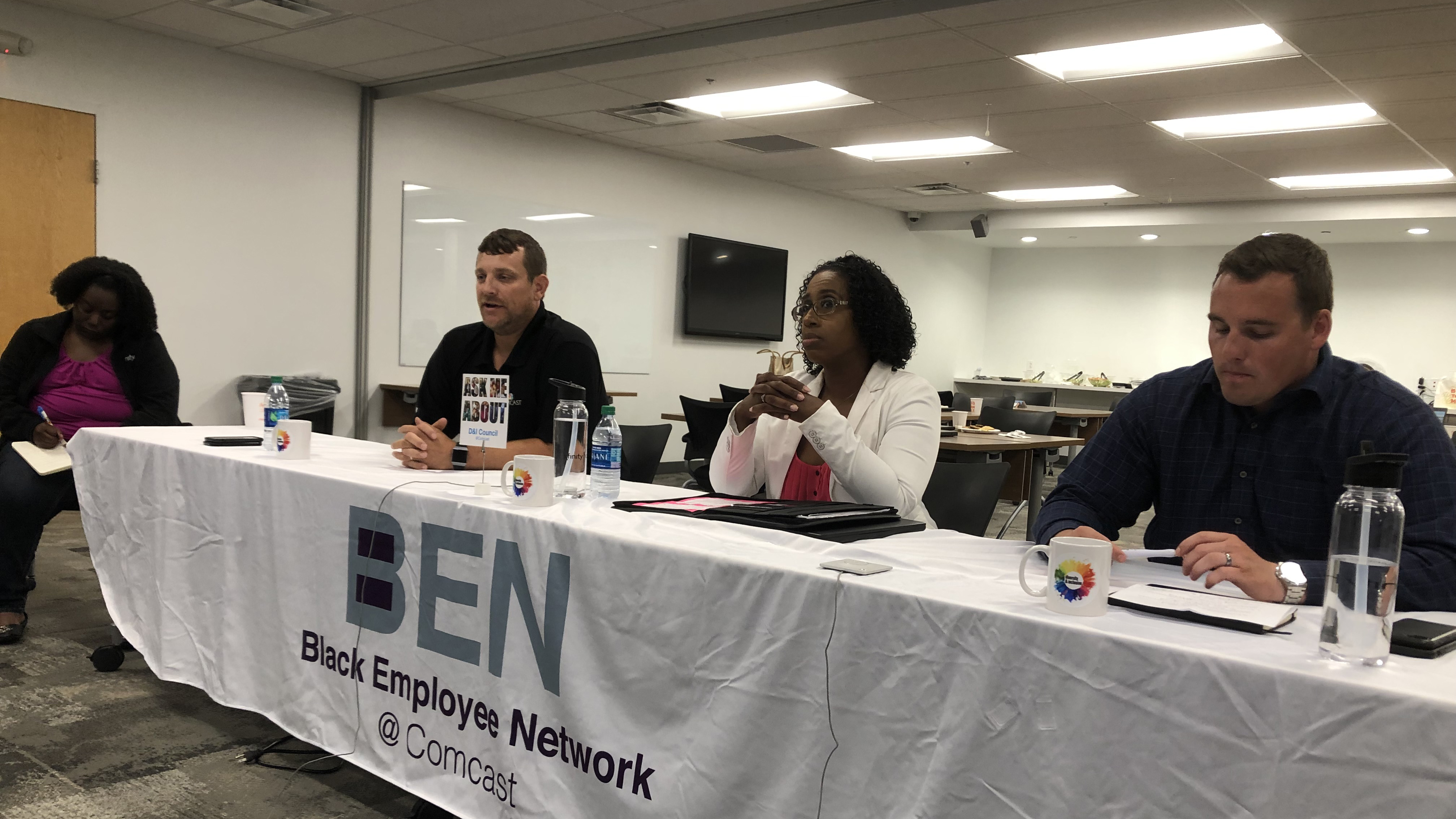 Member of the Black Employee Network sit together at a table.