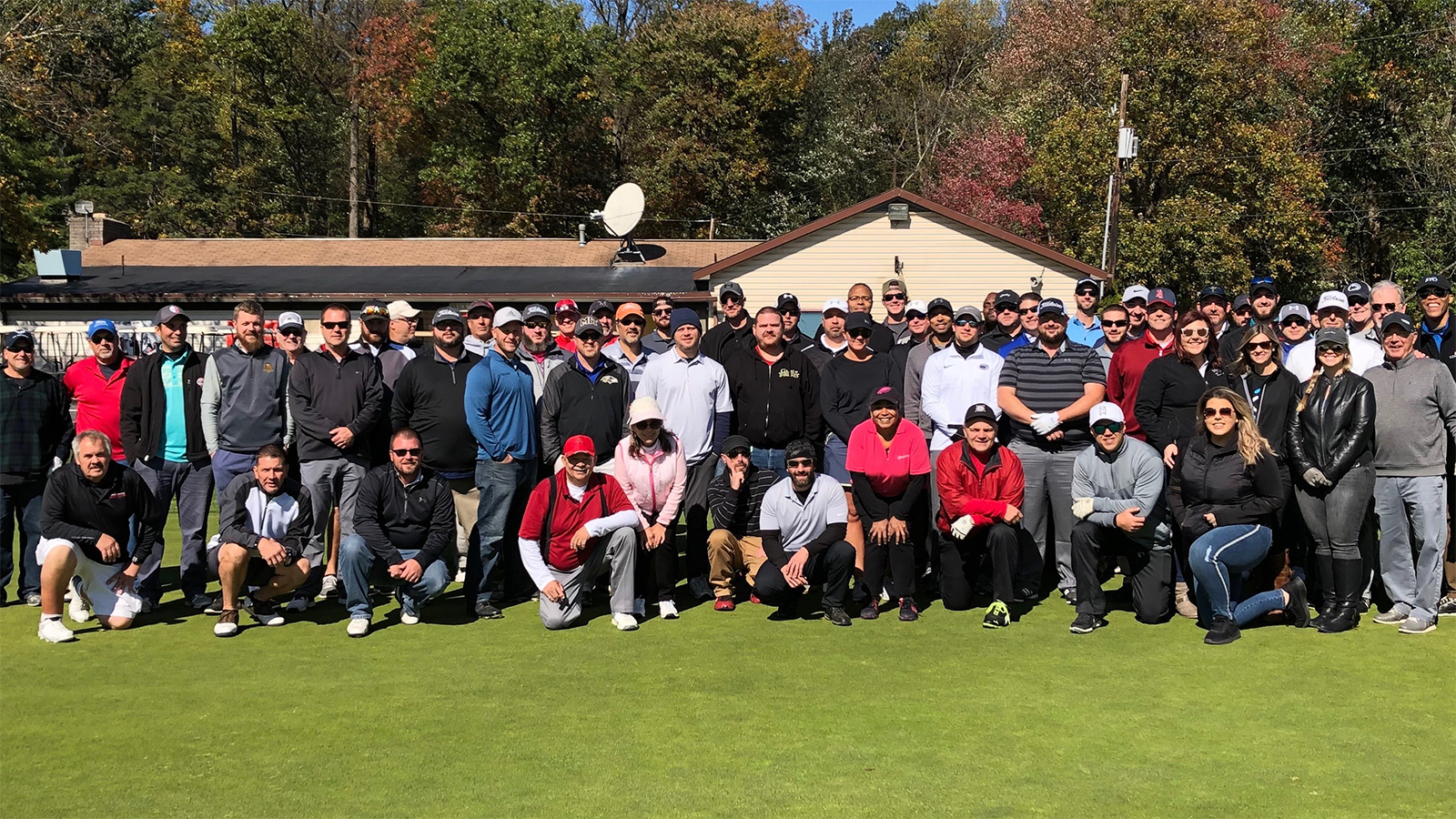 Members of Comcast’s Young Professionals Network stand together in a field.