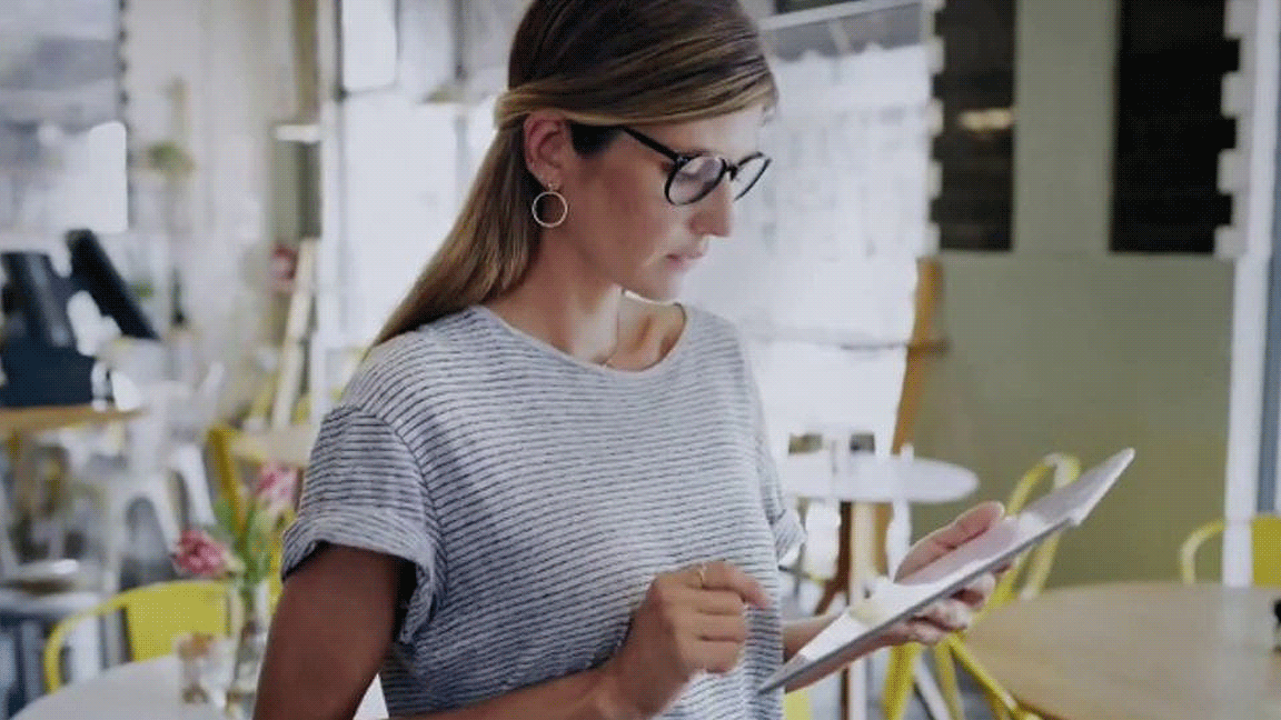 woman looking at tablet