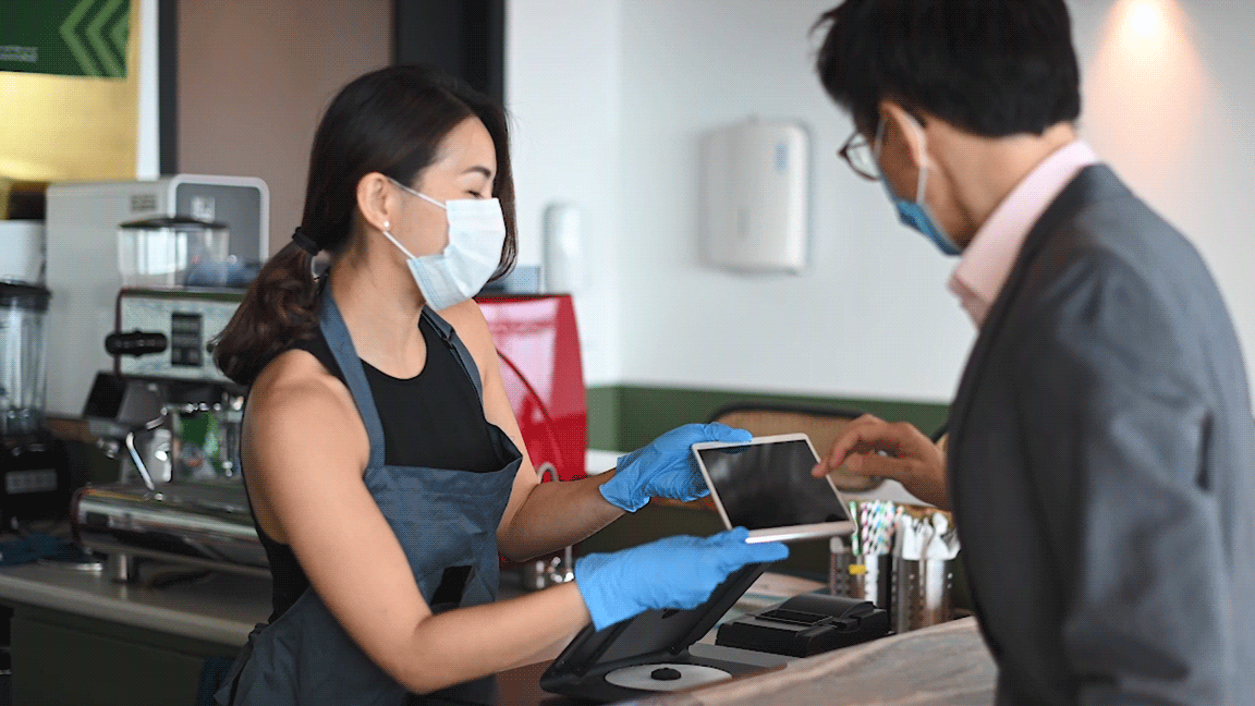 Customer using tablet at small business