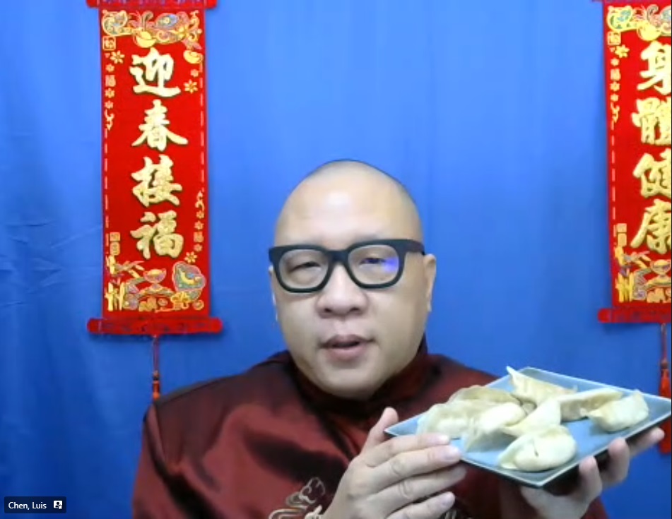 Man holding a plate of dumplings