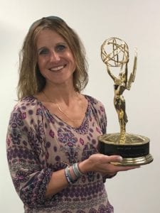 Comcast employee holding Emmy Award