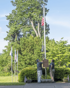 Comcast employees lowering American flag