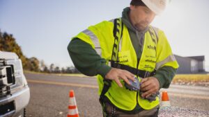 Tec working outdoors with equipment