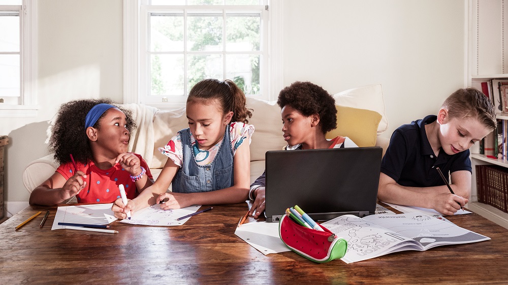 Four children working at a table