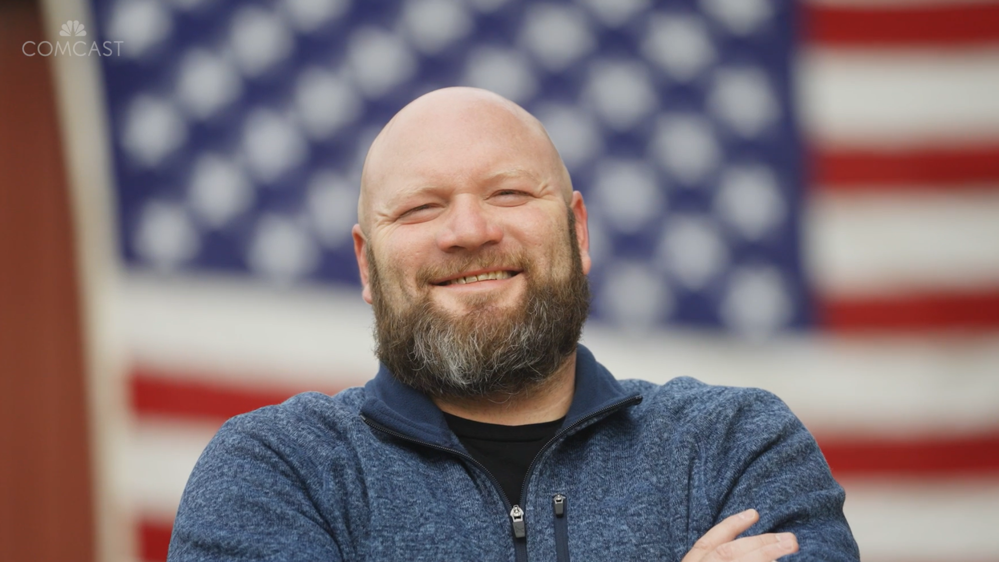 Kevin Hodits, Director of Field Operations and Marine in Comcast’s Keystone Region standing in front of an American flag.